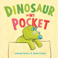 The cover shows a yellow shirt with a little green triceratops poking out of the pocket, smiling. The title “Dinosaur in My Pocket” is written above its head in green and pink font.