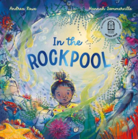 The book cover looks as if you are viewing from the bottom of a rockpool, looking up at a little girl with freckles and curly hair tied on top of her head. Around the rockpool opening are colourful plants and sea creatures. The title “In the Rockpool” is written in the sky above the girl’s head, framed by the rockpool’s circular opening.